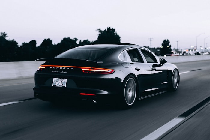 Modern sedan driving on coastal highway
